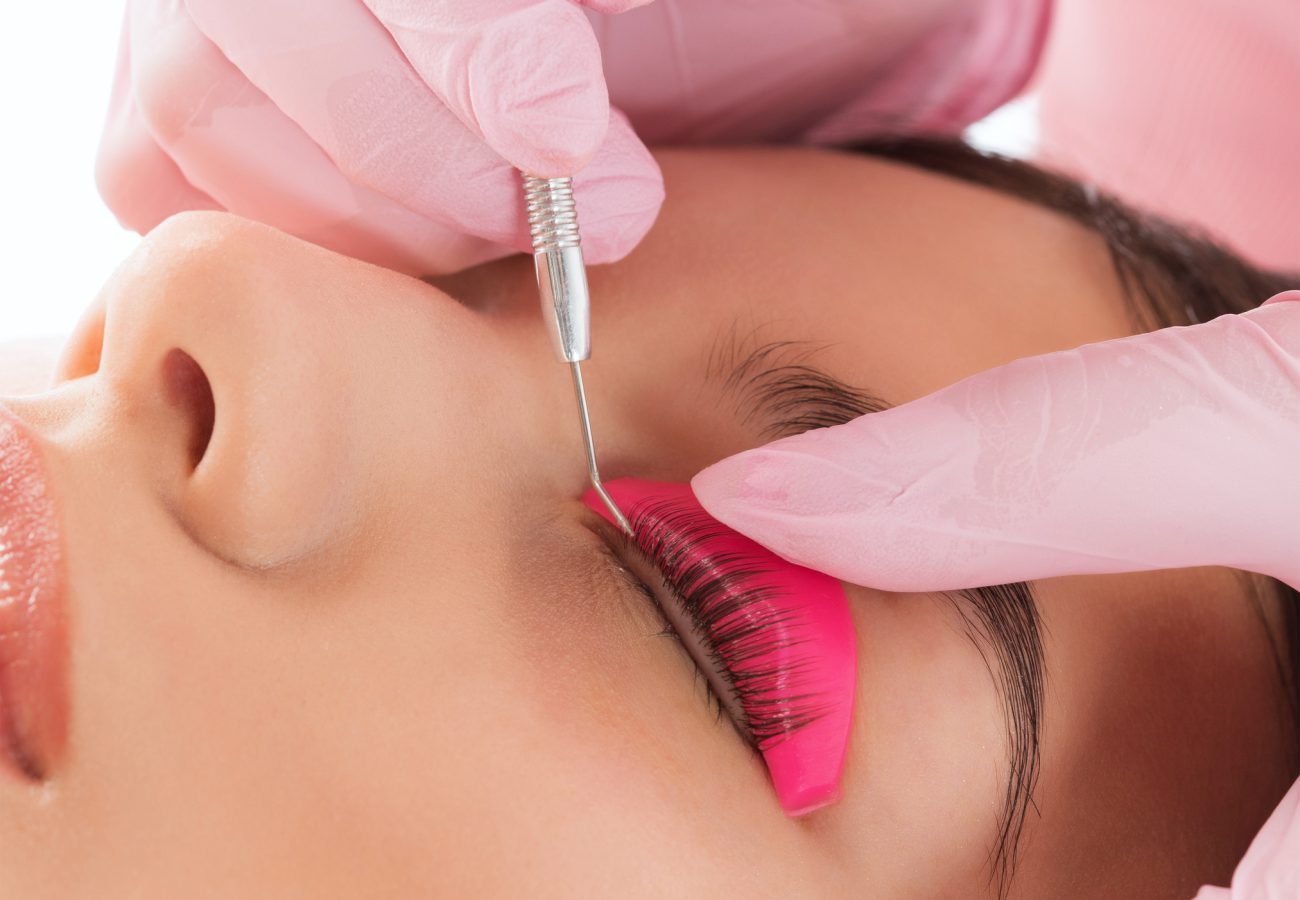 Make-up artist makes the procedure of lamination and dyeing of eyelashes to a beautiful woman in a beauty salon. Eyelash extensions. Eyelashes close-up Make-up artist makes the procedure of lamination and dyeing of eyelashes to a beautiful woman in a beauty salon. Eyelash extensions. Eyelashes close-up